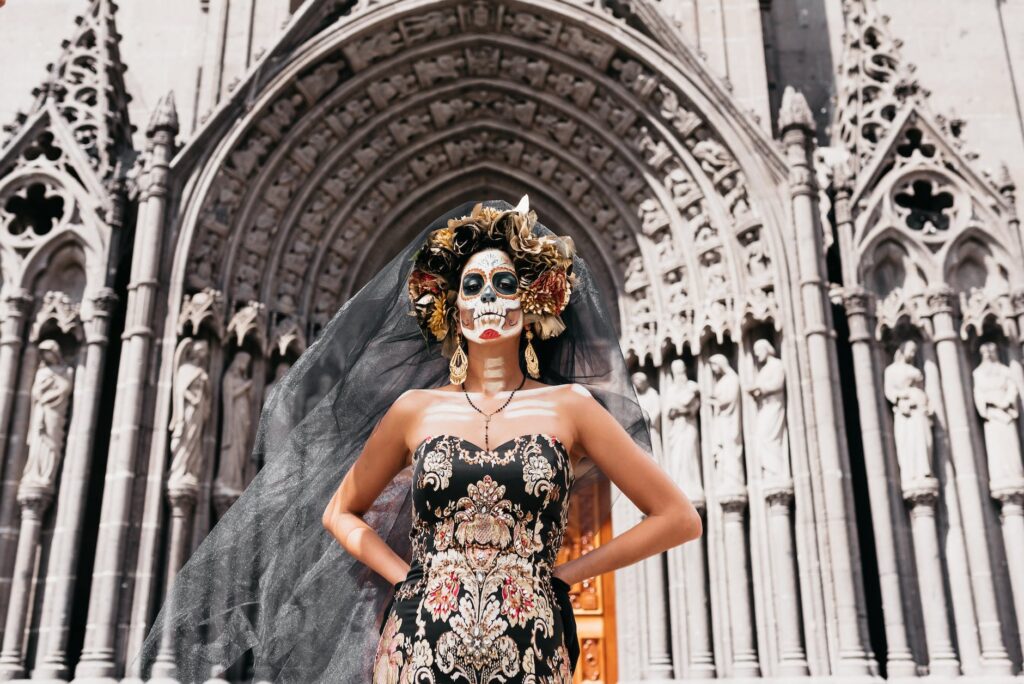 woman in makeup and costume to celebrate the day of the dead in mexico